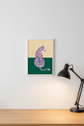 Tiger Yellow Green print framed next to a desk lamp