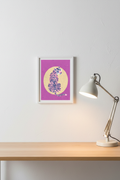 Tiger Yellow Sun print framed next to a desk lamp