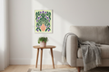 Orange Vase Purple Bloom print framed in a living room